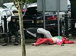 Harrowing video shows Spice 'Zombies' slumped lifeless on town centre street as pedestrians walk by